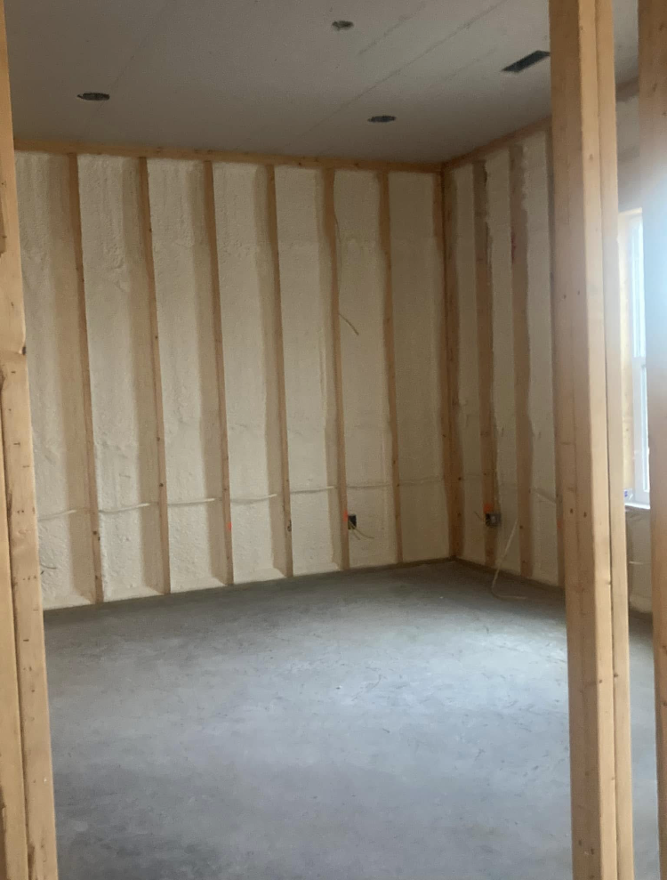 An empty room with wooden walls and a concrete floor.