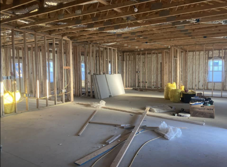 A large room with a lot of wood in it is being built.