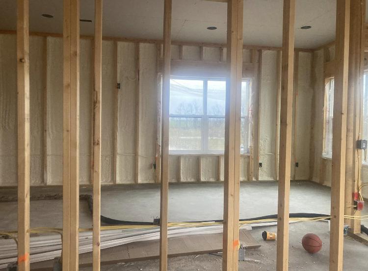 A room with a lot of wooden beams and a window.