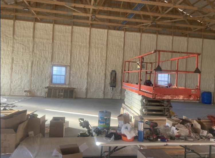 A large room with a table and a lift in it.