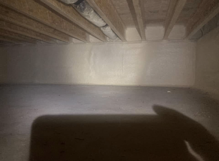 A person is holding a flashlight in a dark room.