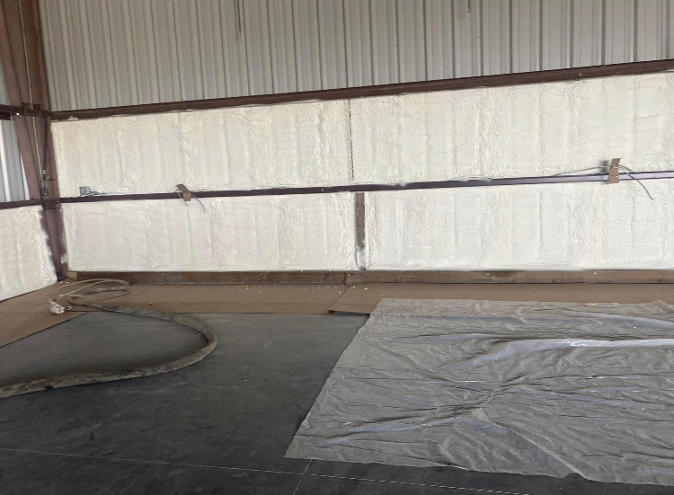 A room with a lot of foam on the walls and a tarp on the floor.