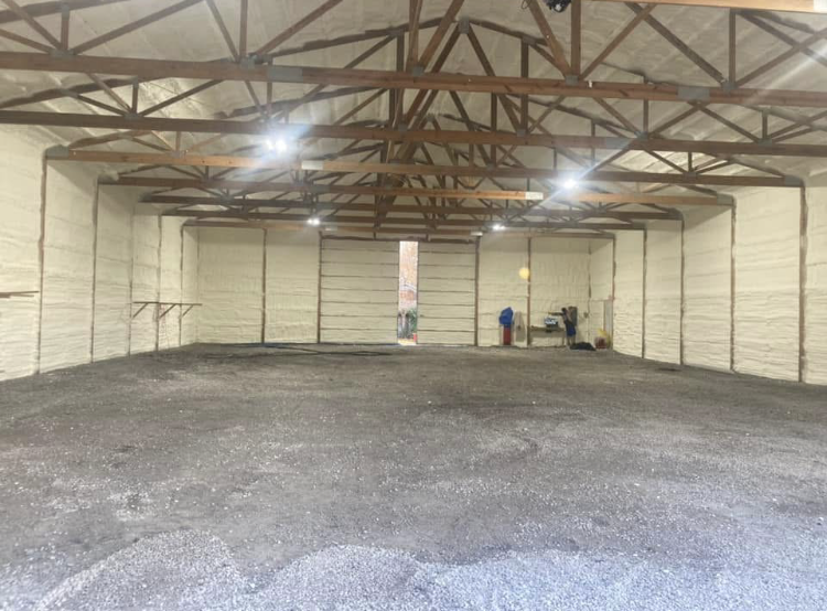 A large empty warehouse with a large garage door.