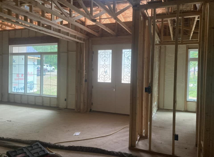 The inside of a house under construction with a lot of windows.