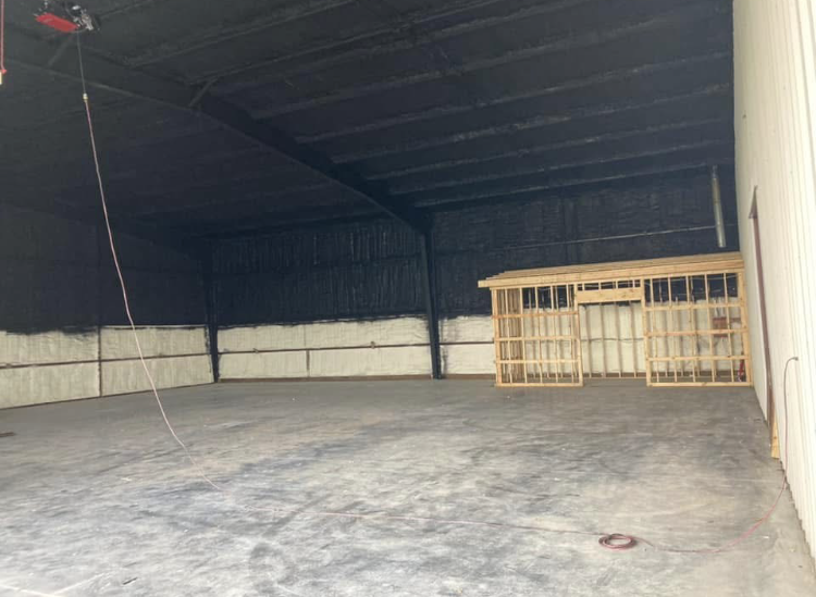 A large empty warehouse with a lot of insulation on the walls and ceiling.