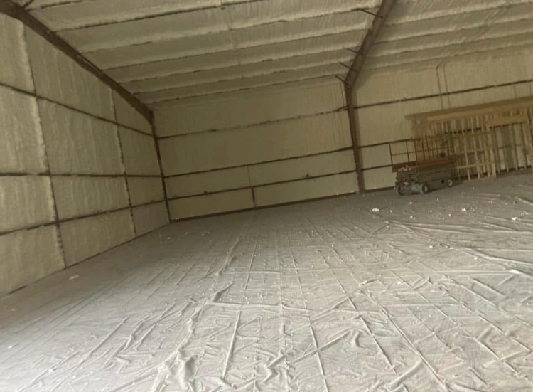 A large warehouse with a lot of insulation on the walls and floor.