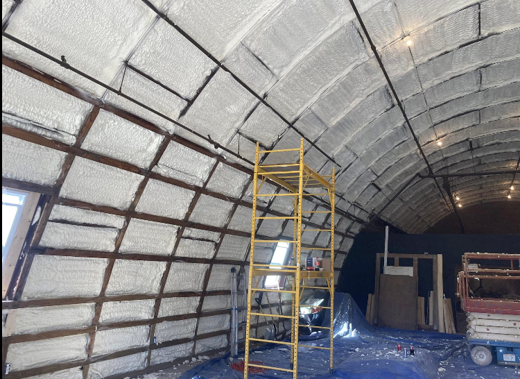 A large building with a ladder in the middle of it.