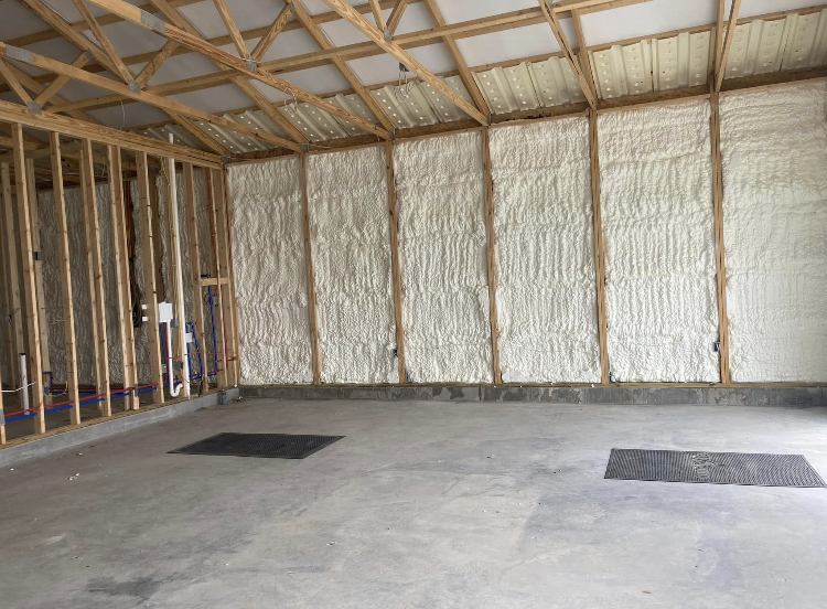 A garage with foam insulation on the walls and ceiling.