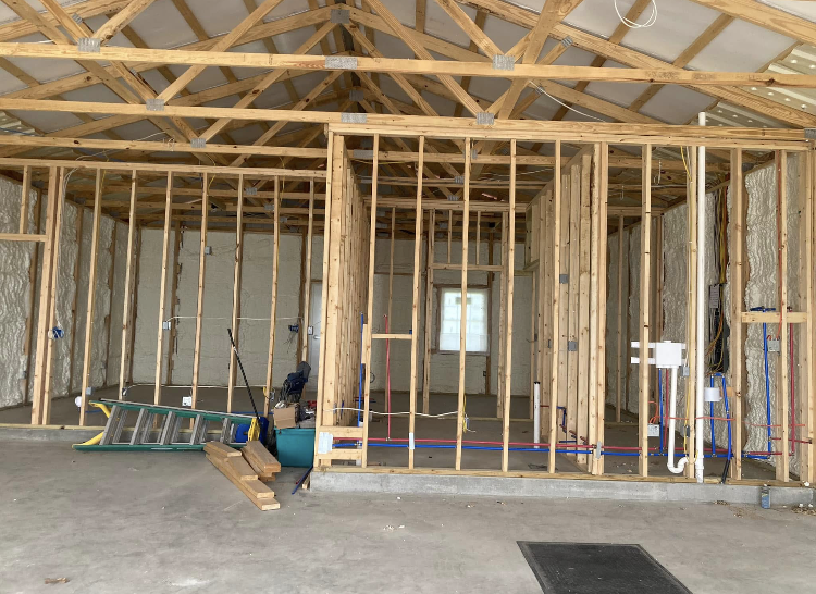 A ladder is sitting in the middle of a building under construction.