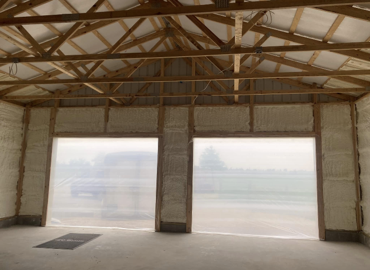 A garage with a lot of insulation on the walls and ceiling.