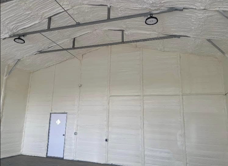 A large room with a door and a ceiling covered in foam.