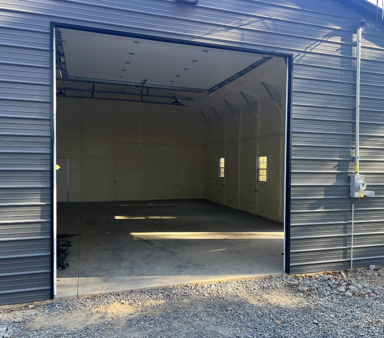 An empty garage with the door open