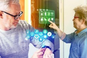 A man and a woman are looking at a smart watch.