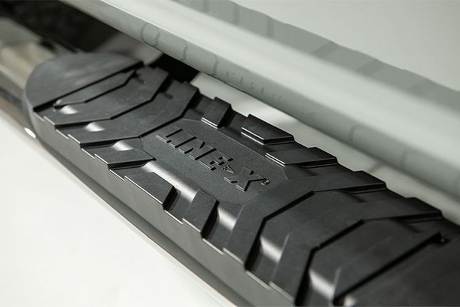 A close up of a black side step on a car