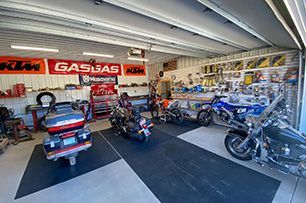 A store filled with motorcycles and scooters.