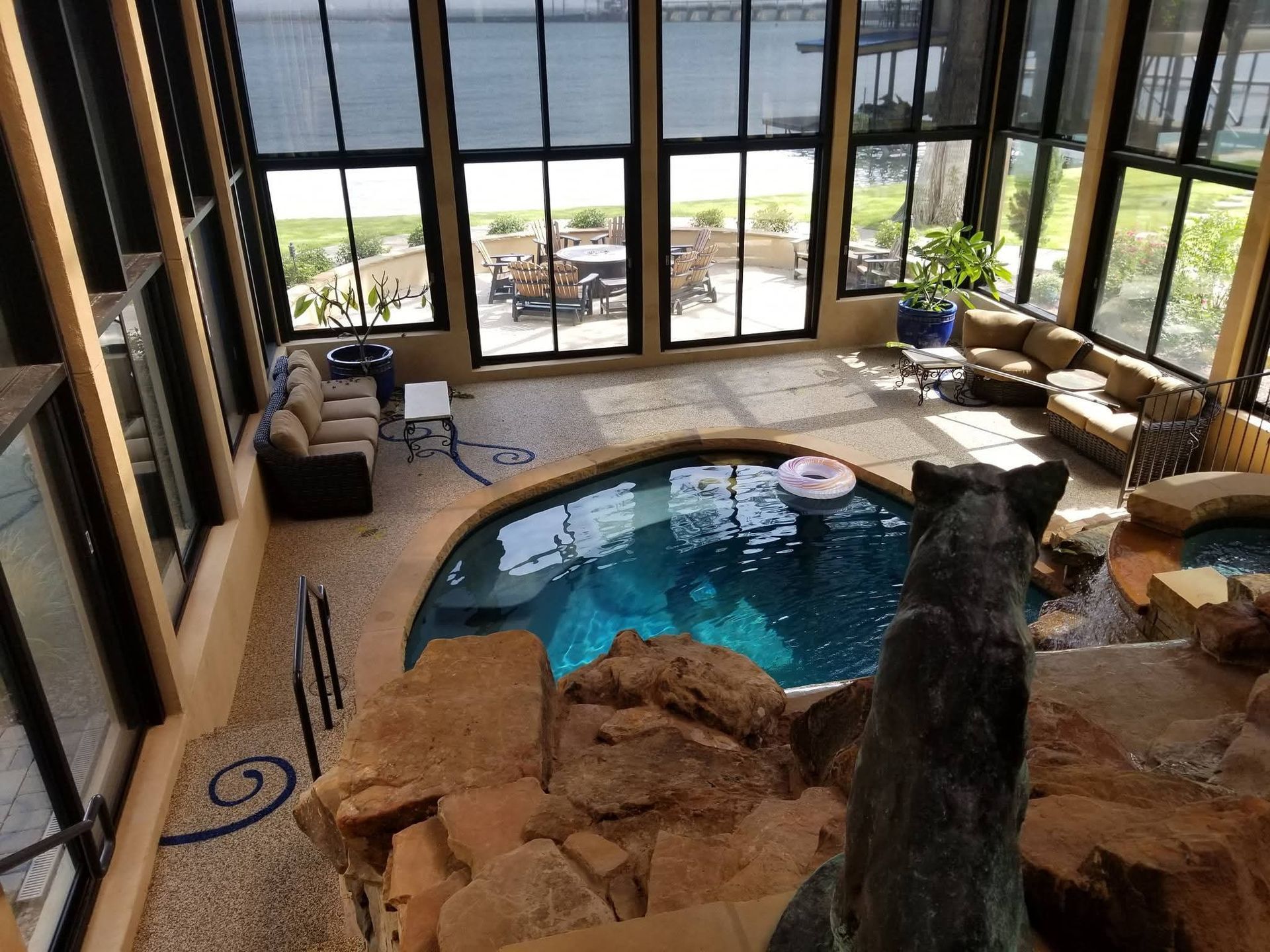 A large room with a swimming pool and a lot of windows