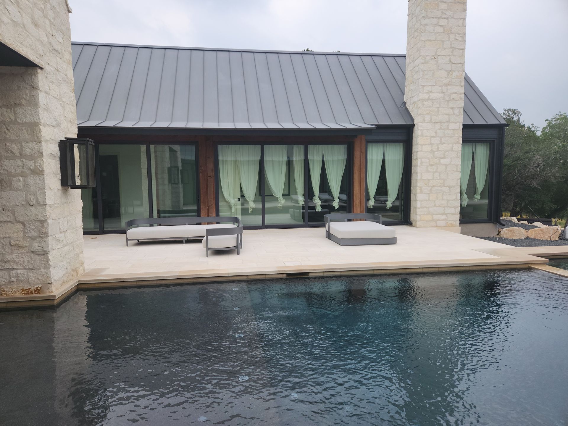 A large house with a swimming pool in front of it