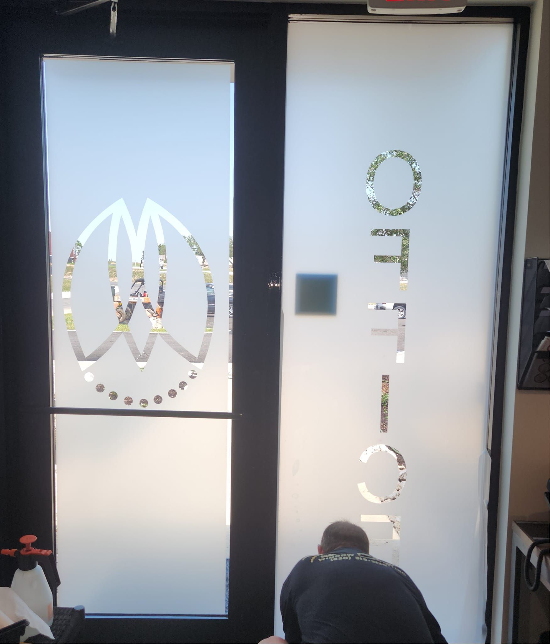 A glass door with the word office on it