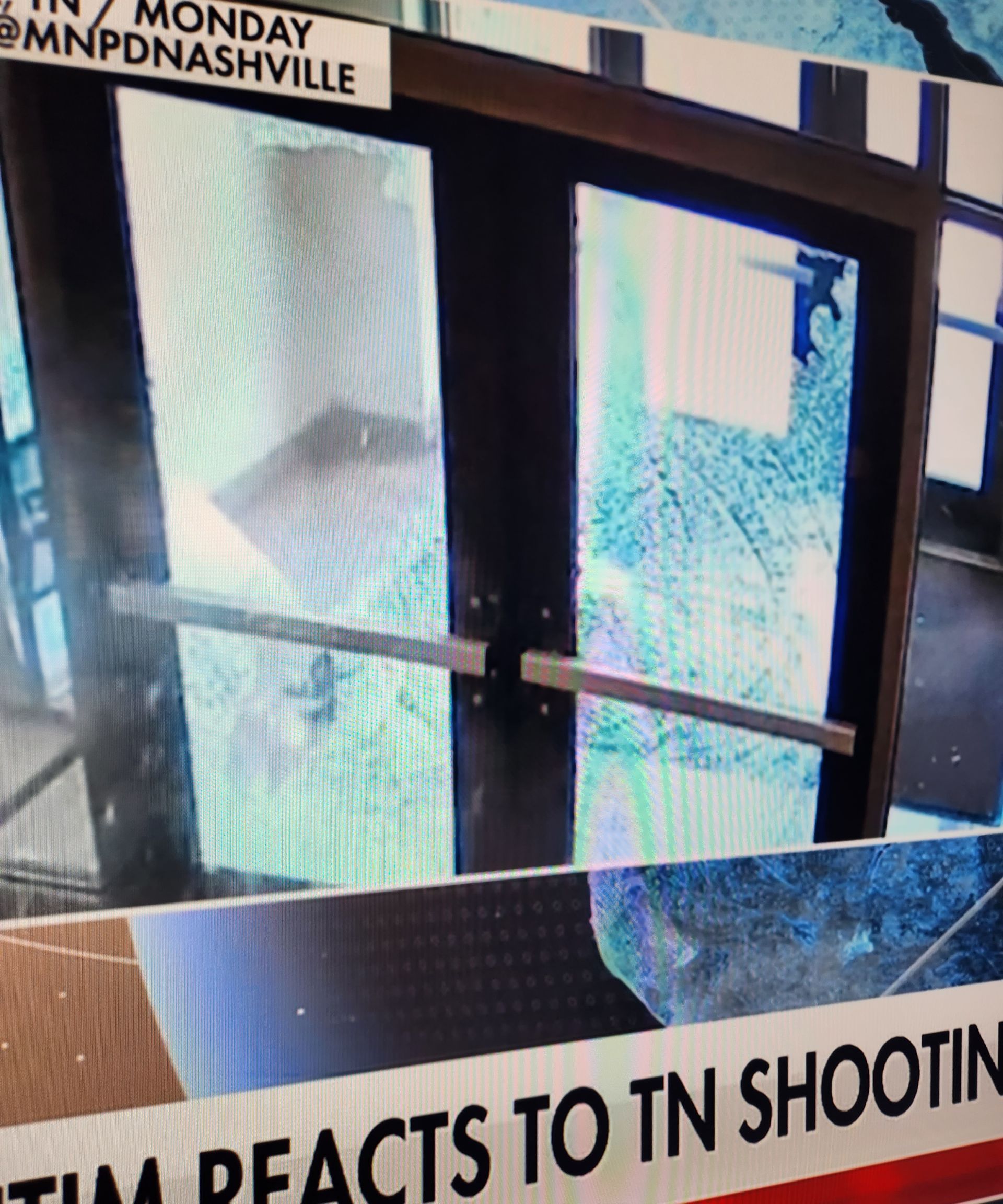 A tv screen shows a door that says tim reacts to tn shootin