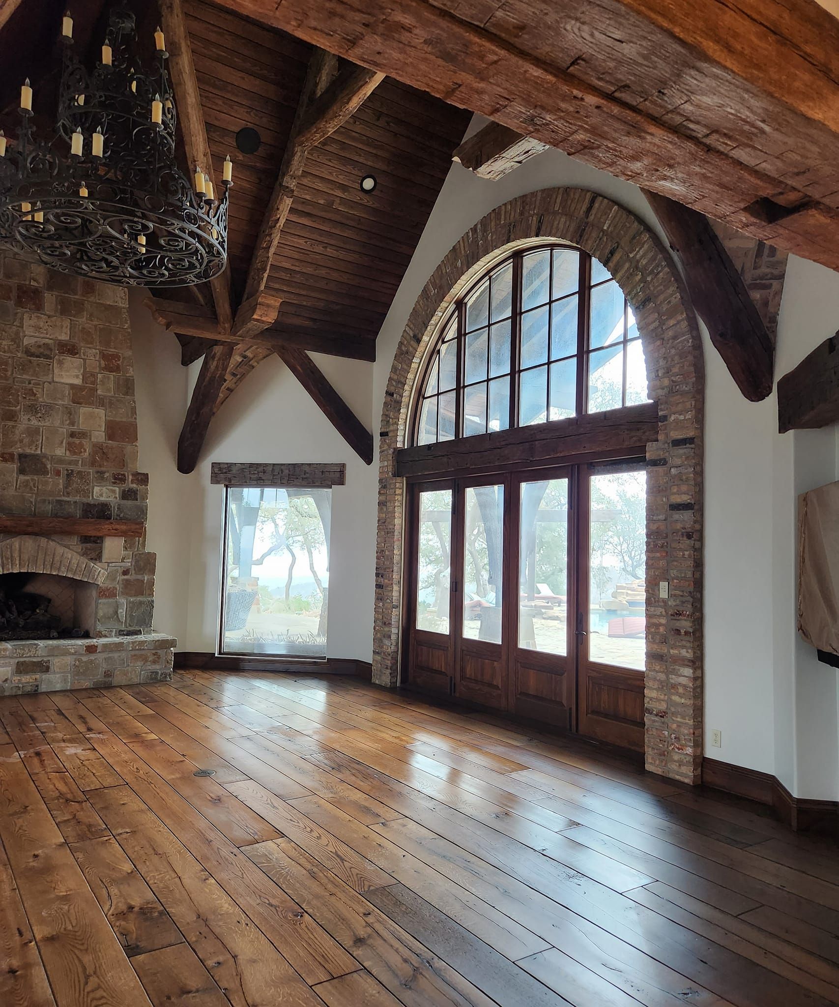 A large room with arched windows and a fireplace