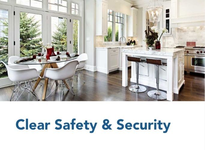 A kitchen with a table and chairs and the words clear safety & security