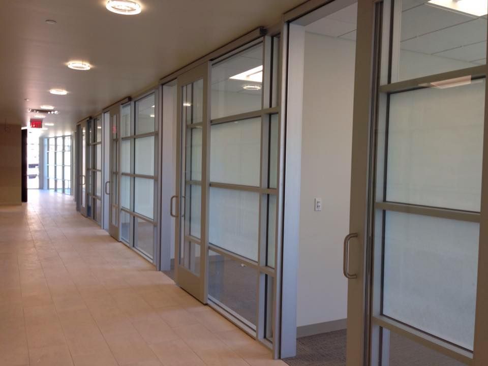 A hallway with a lot of windows and doors