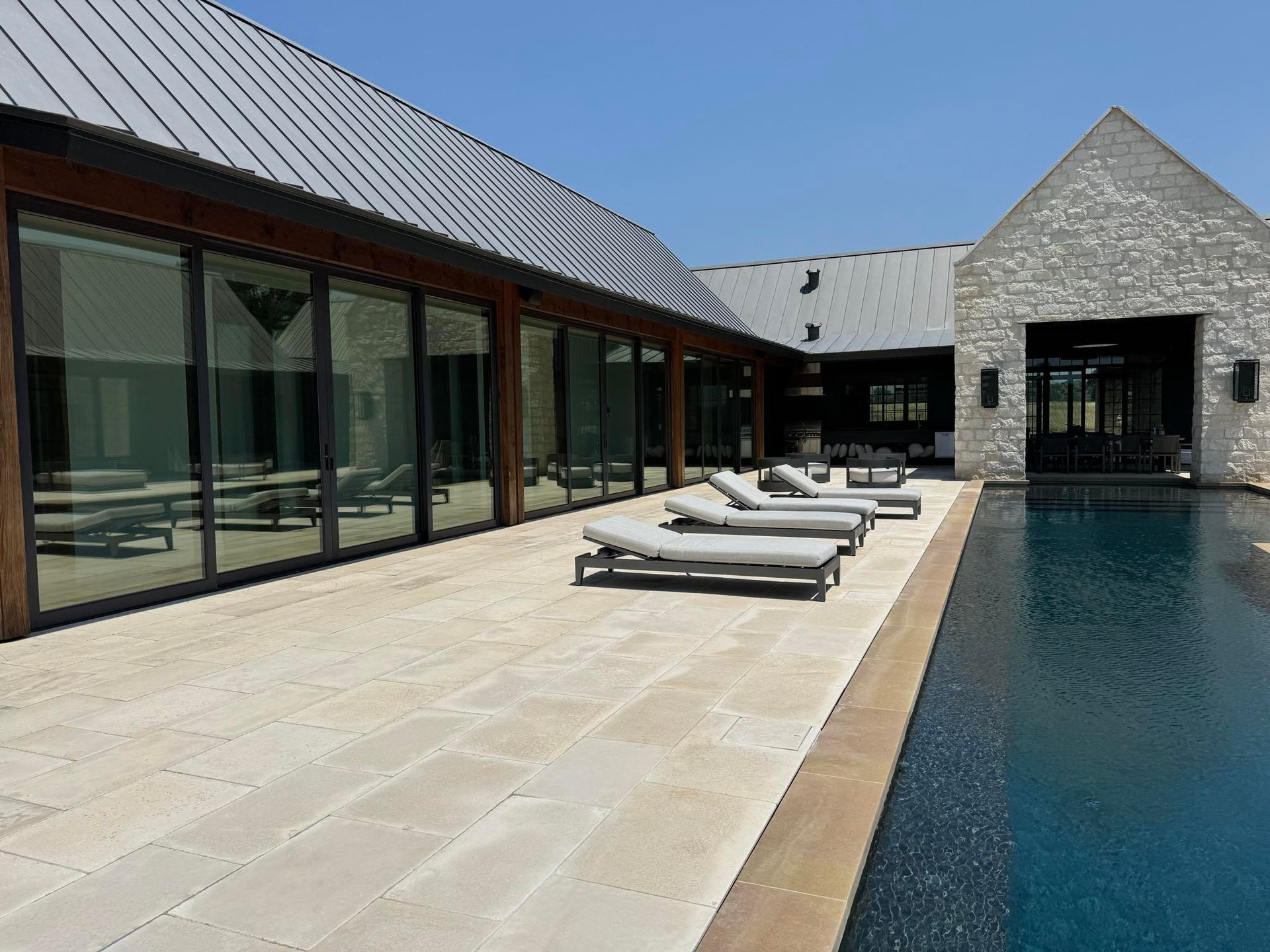A large house with a large swimming pool in front of it