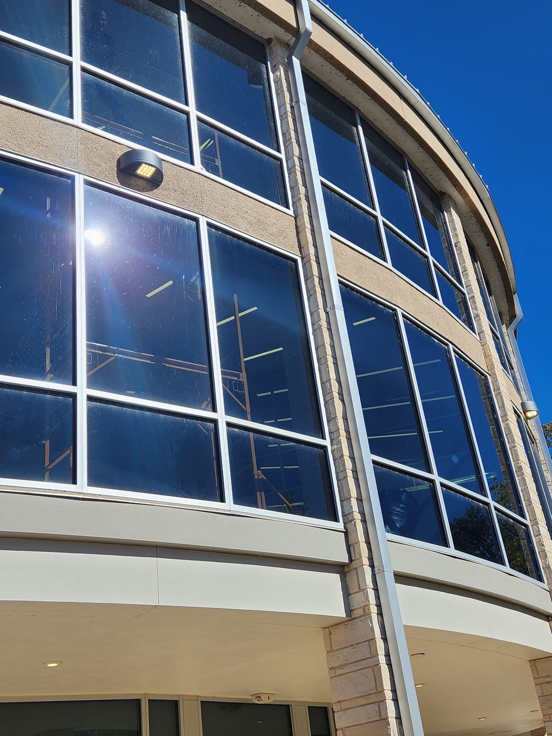 A building with a lot of windows and a blue sky in the background