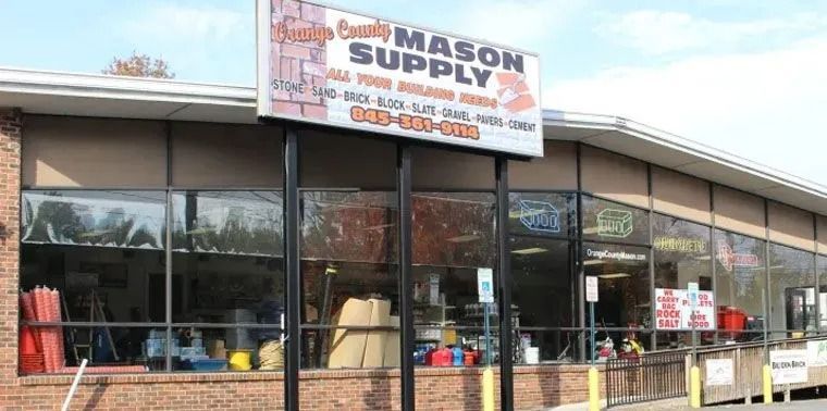 Exterior of Brady Mason Supply, a brick-faced building with a large sign.