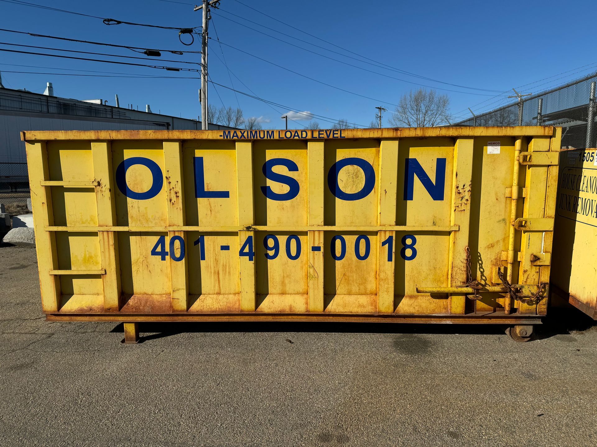 20-yard dumpster with the word Olson on it
