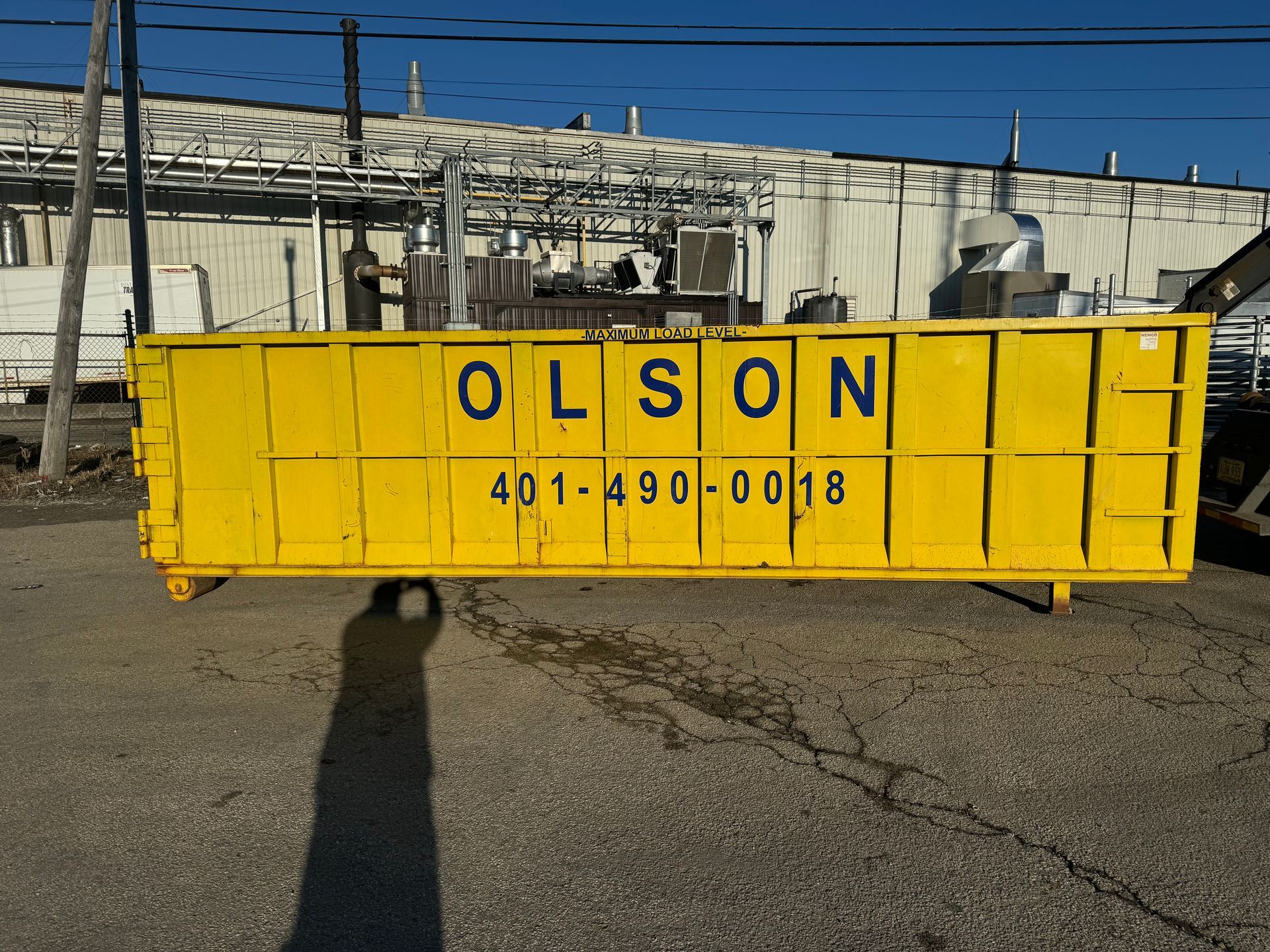 A 30-yard dumpster with Olson written on it