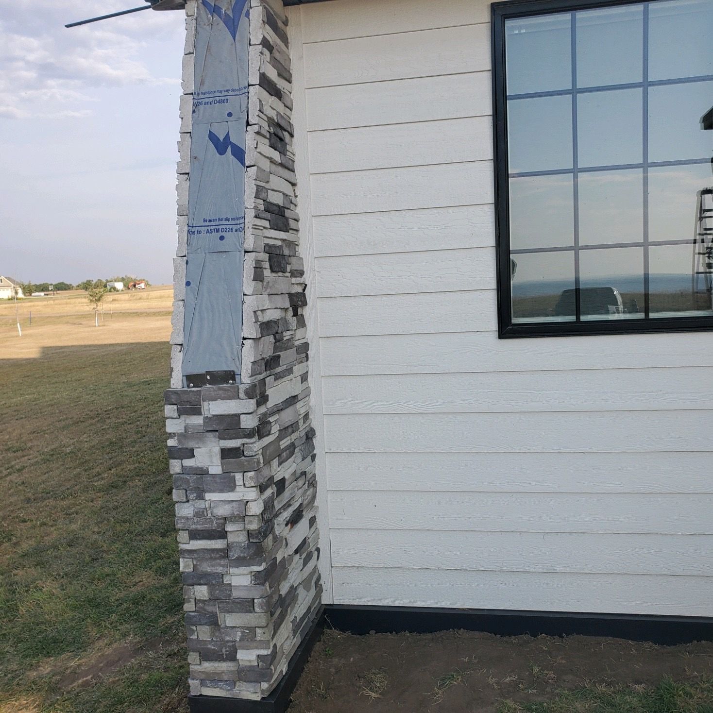A white house with a chimney and a window