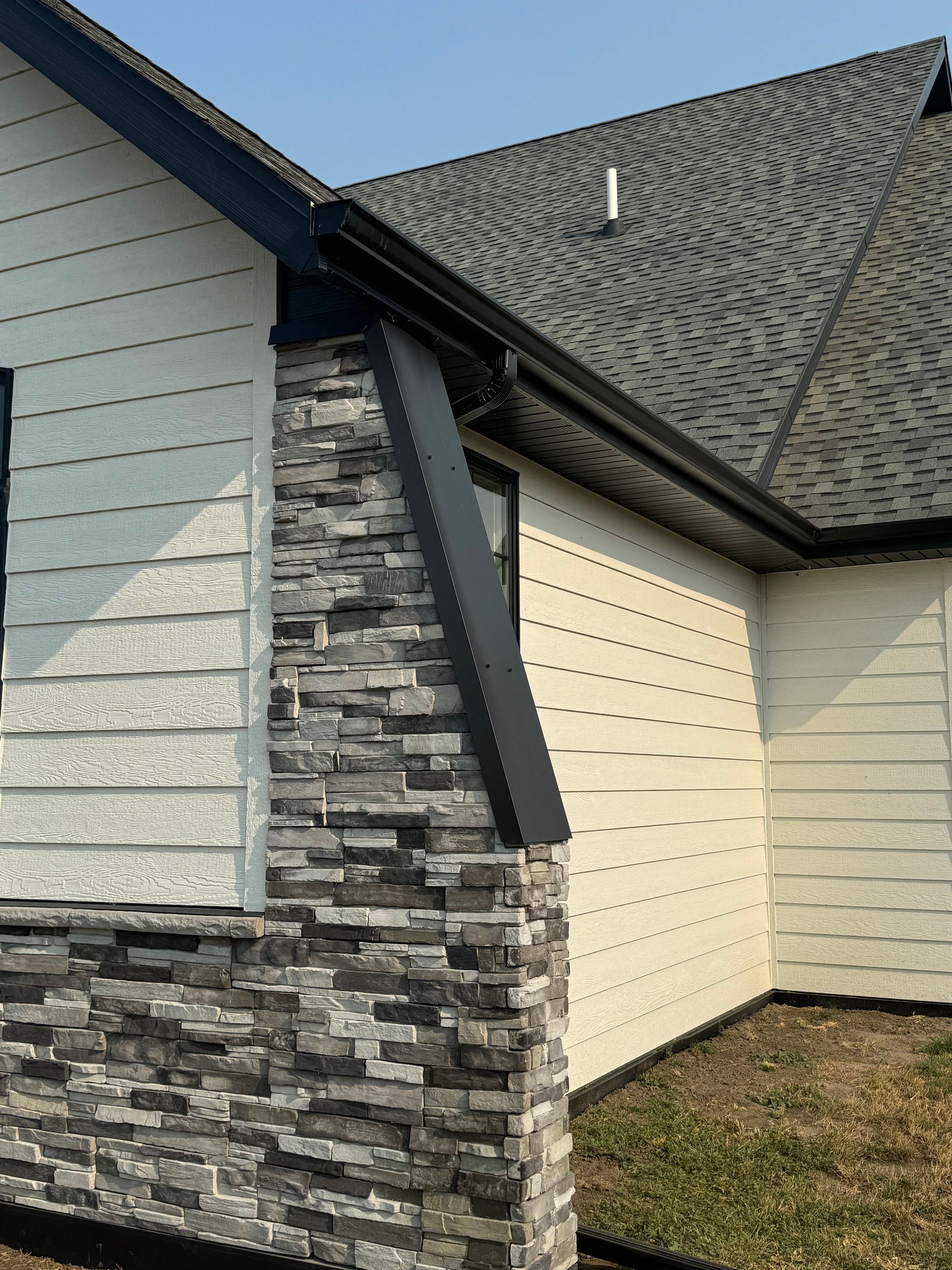 A house with a stone chimney on the side of it