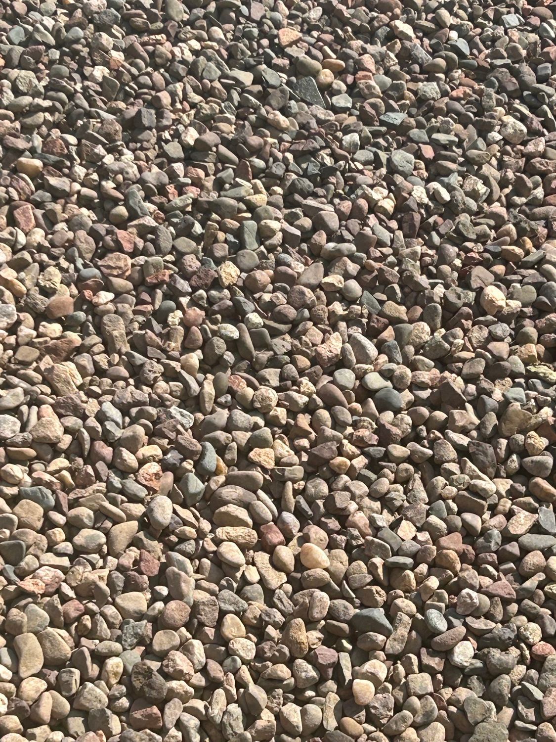 Gravel, assorted colors including brown, gray, and tan.