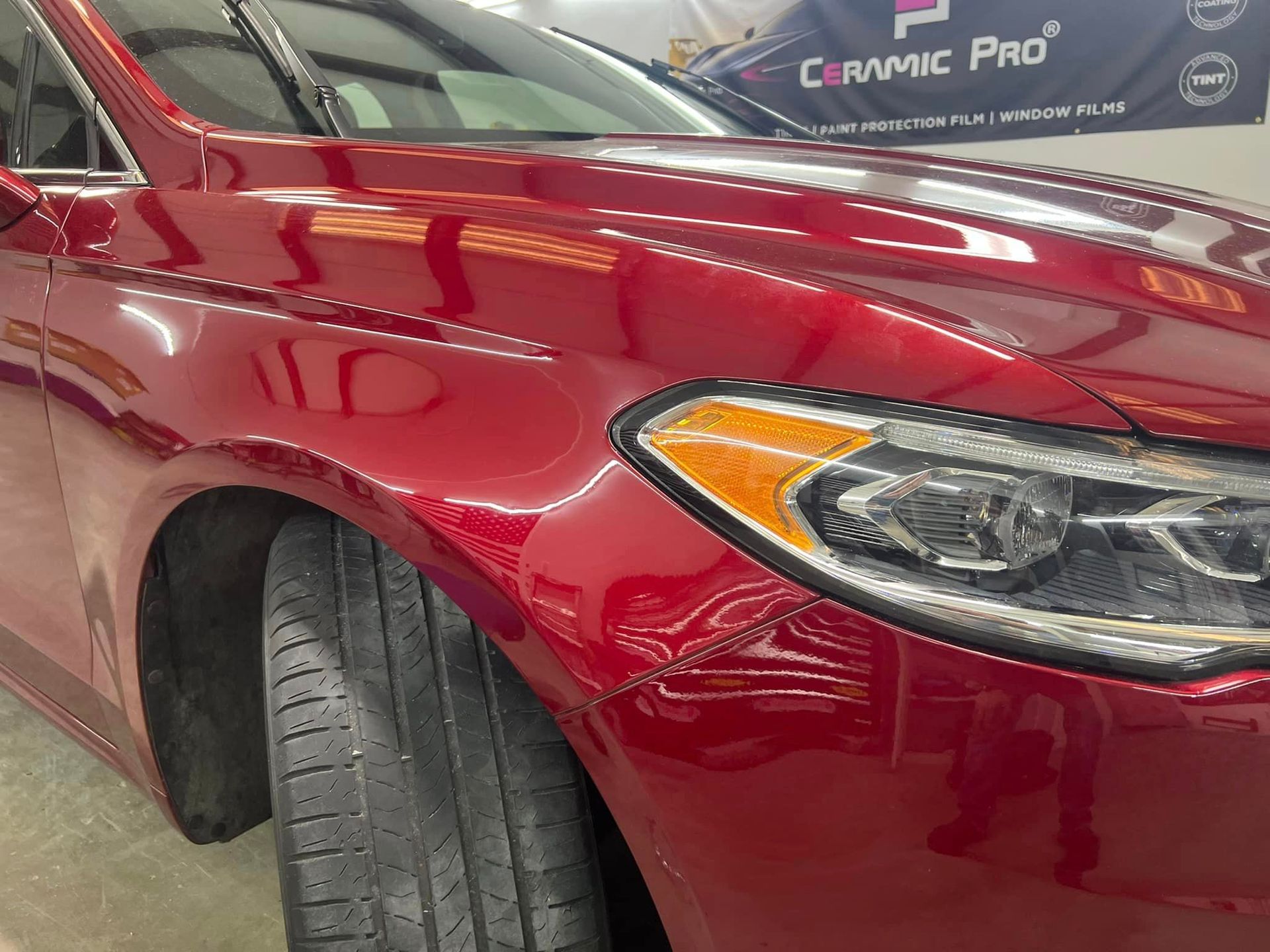 after photo of a repaired dent in a deep red car