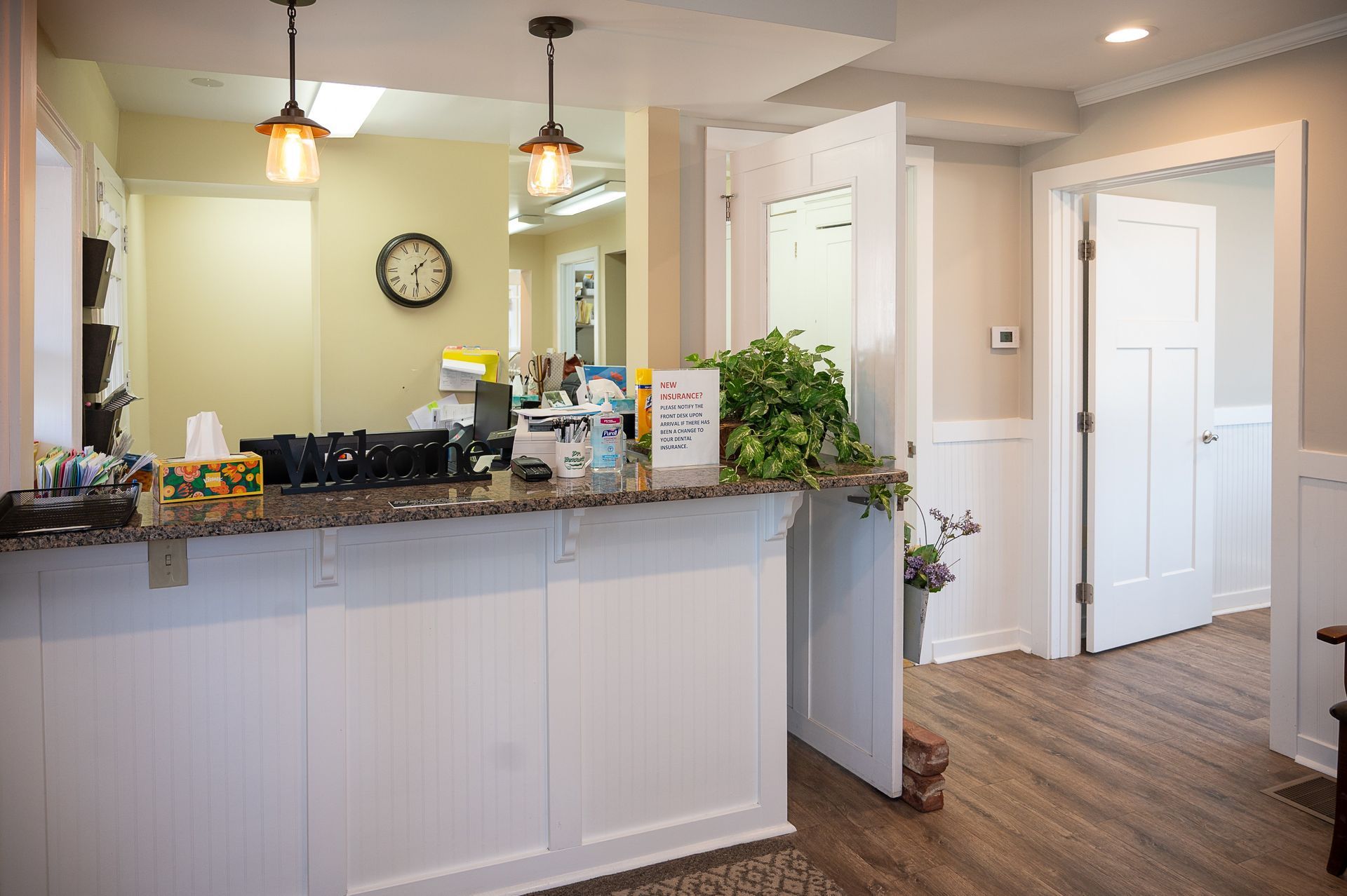 A dental office with a counter and a clock on the wall