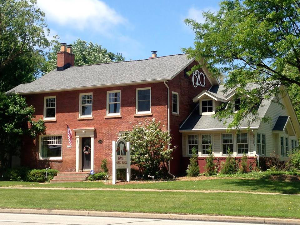 A large red brick house with a gray roof