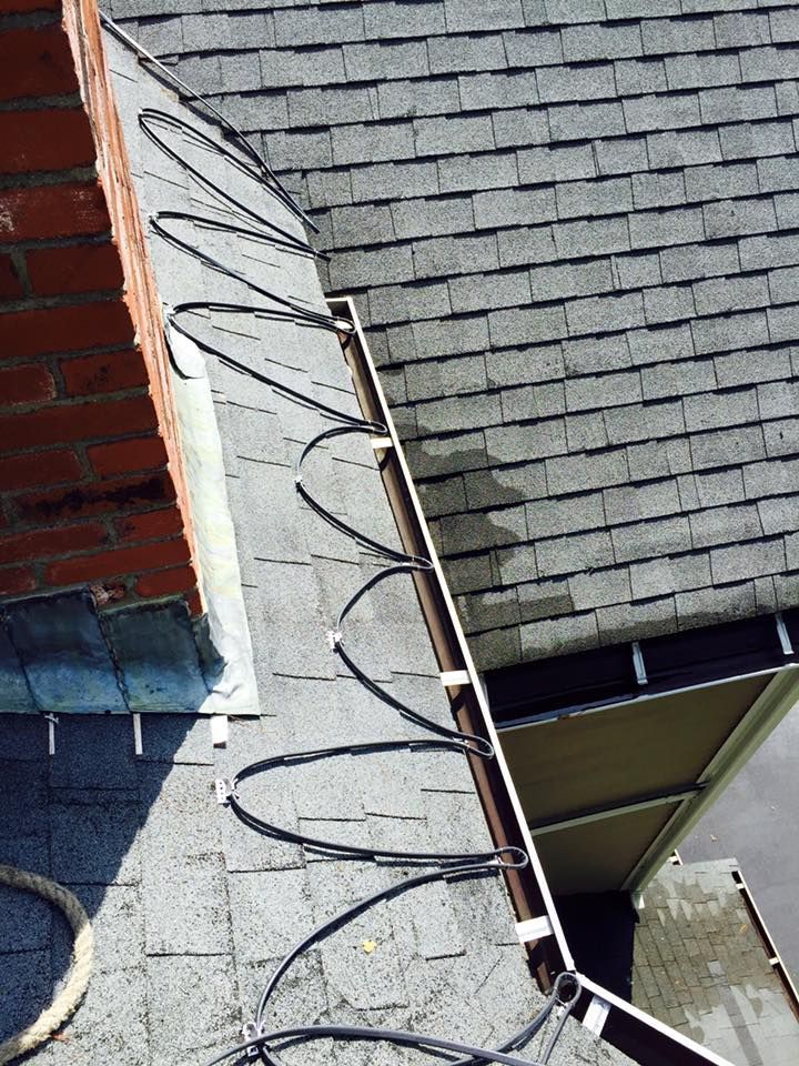 A close up of a roof with a bunch of wires on it.