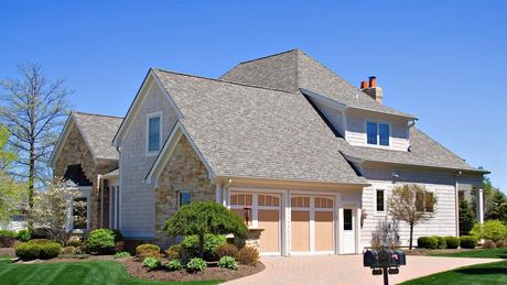 A large house with a mailbox in front of it