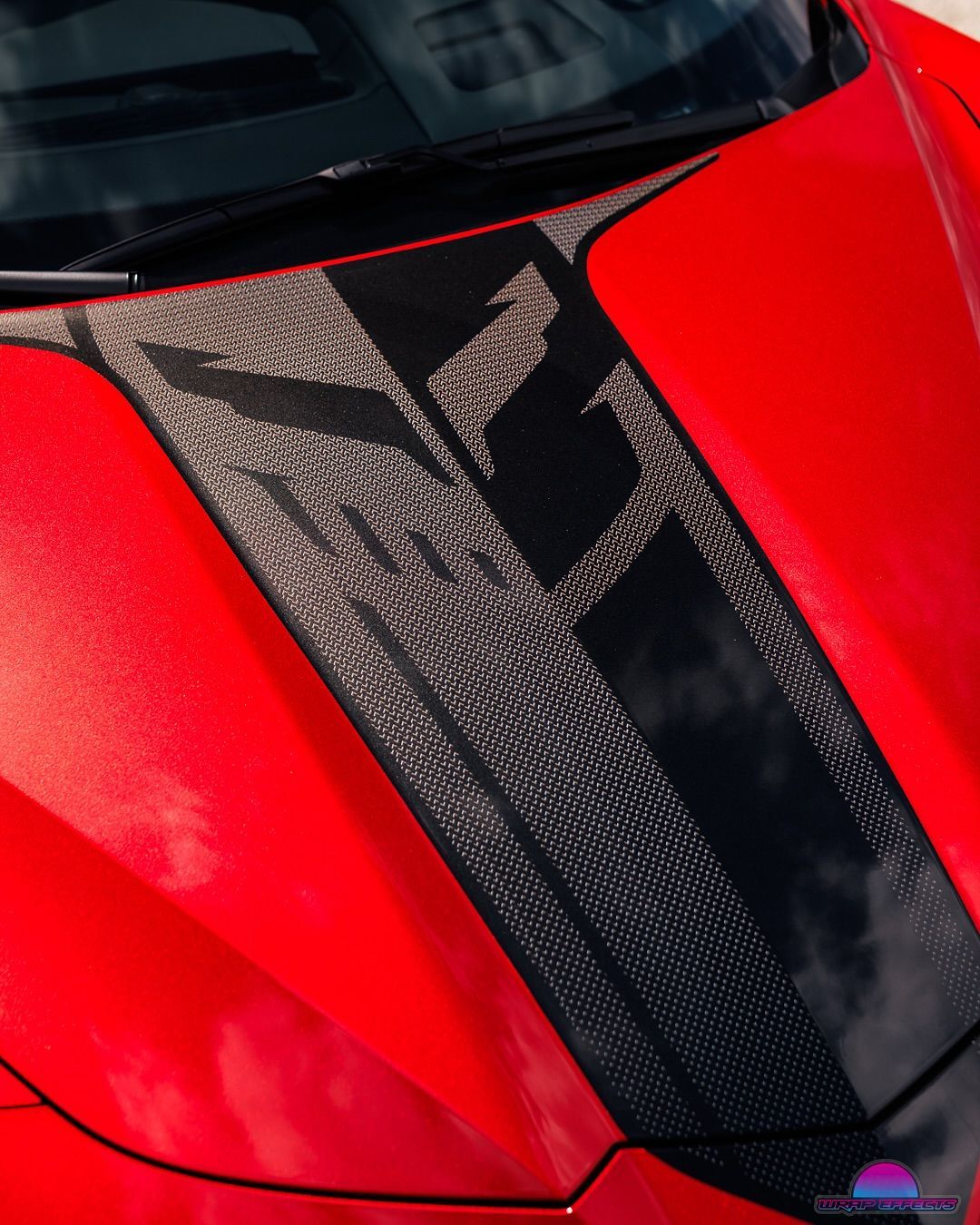 Red car hood with carbon fiber Z06 graphic.