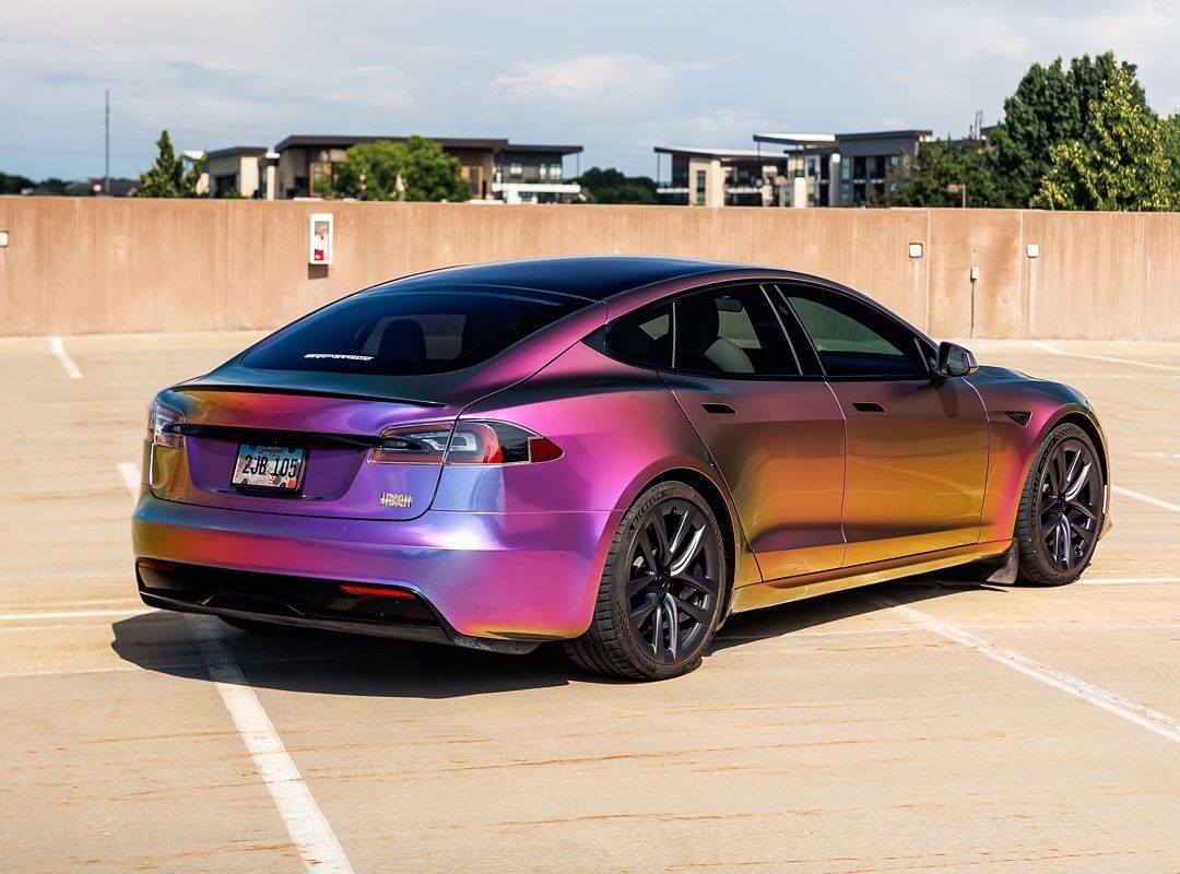 Tesla Model S with color-shifting wrap parked in a parking garage.