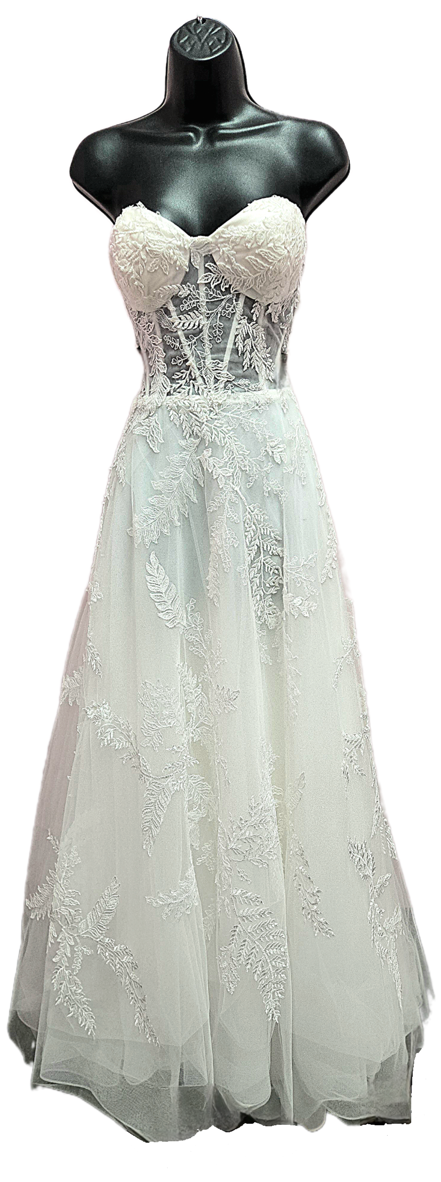 White strapless wedding dress on a black mannequin, with a fitted bodice and a flowing skirt.