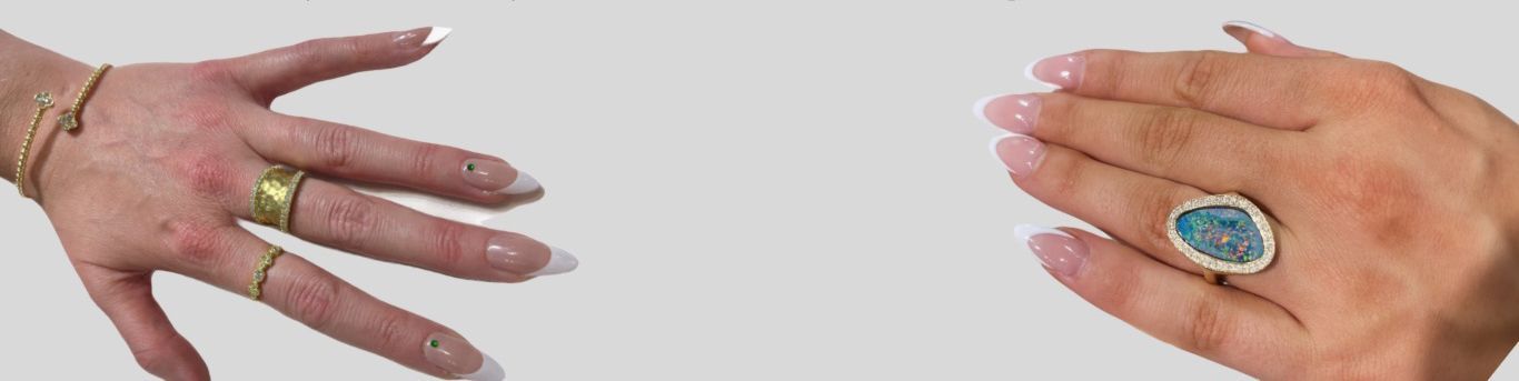 A close up of a woman's hand with a ring on it.