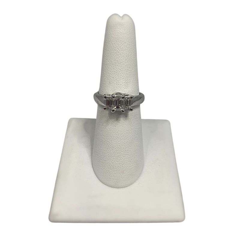 A ring is sitting on top of a white ring holder.