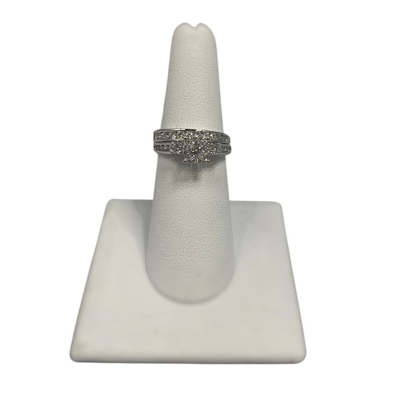A ring is sitting on top of a white ring holder.