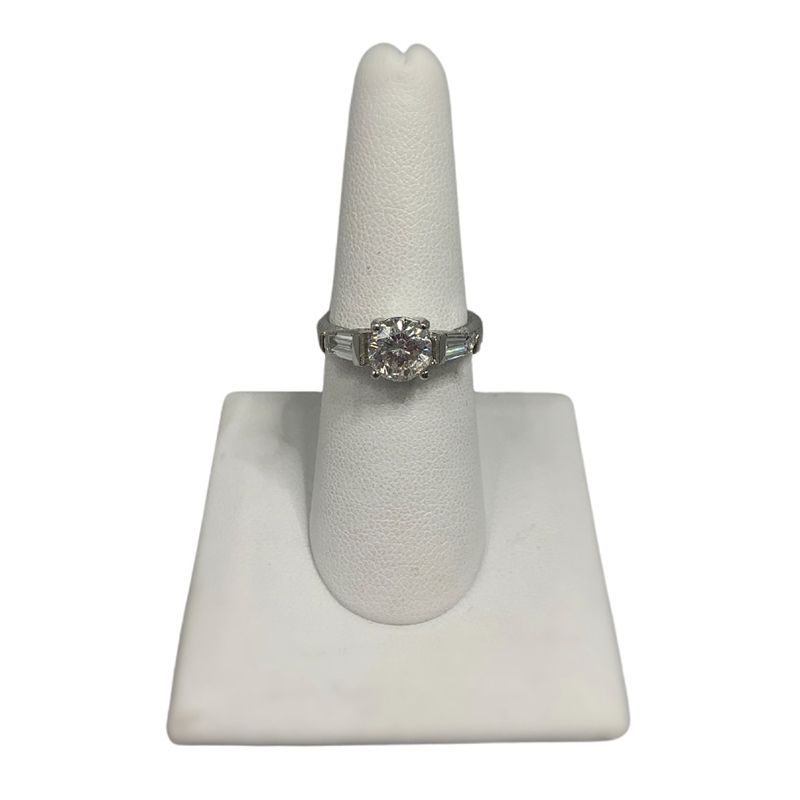 A ring is sitting on a white ring holder.