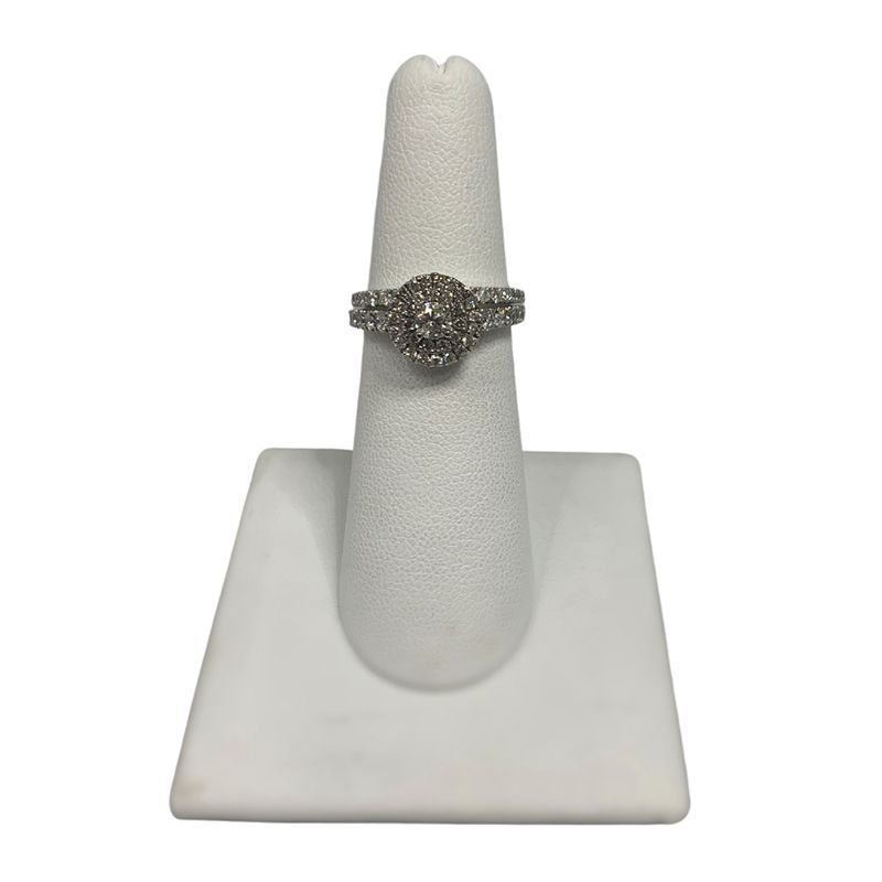 A white ring holder with a ring on it