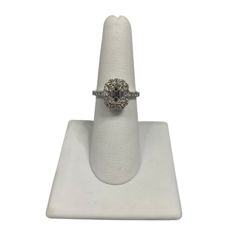 A diamond ring is sitting on a white ring holder.