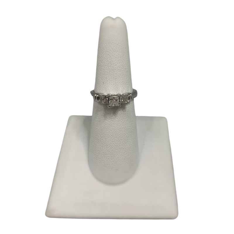 A white ring holder with a ring on it