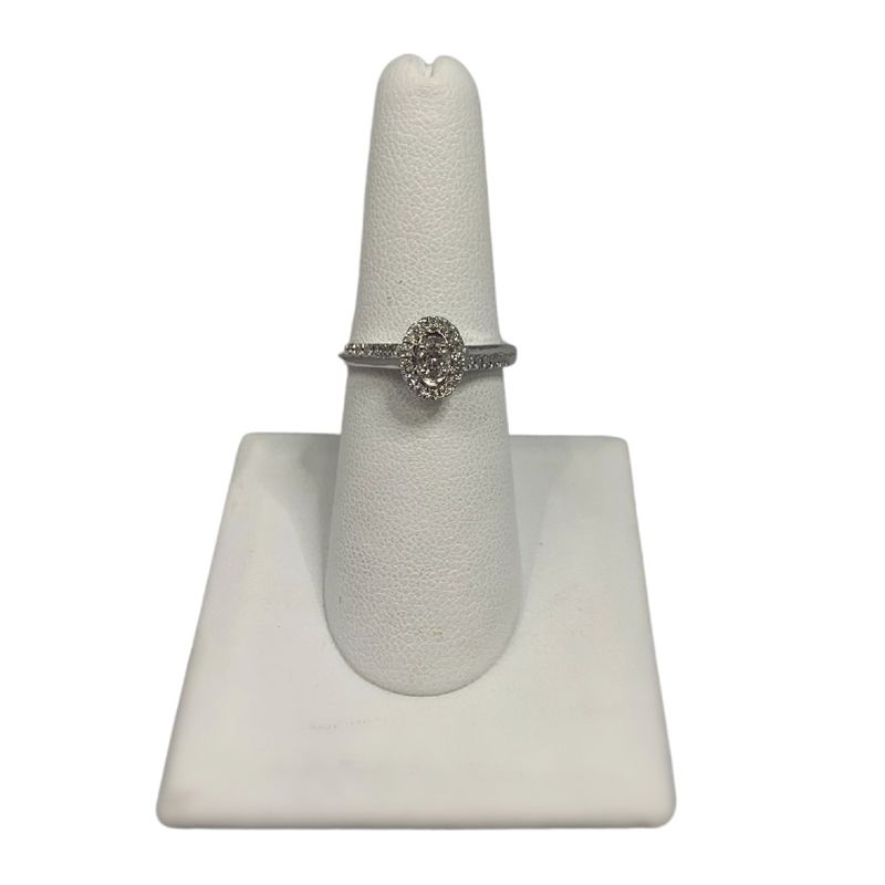 A ring is sitting on top of a white ring holder.